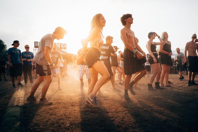 people dancing during sunset