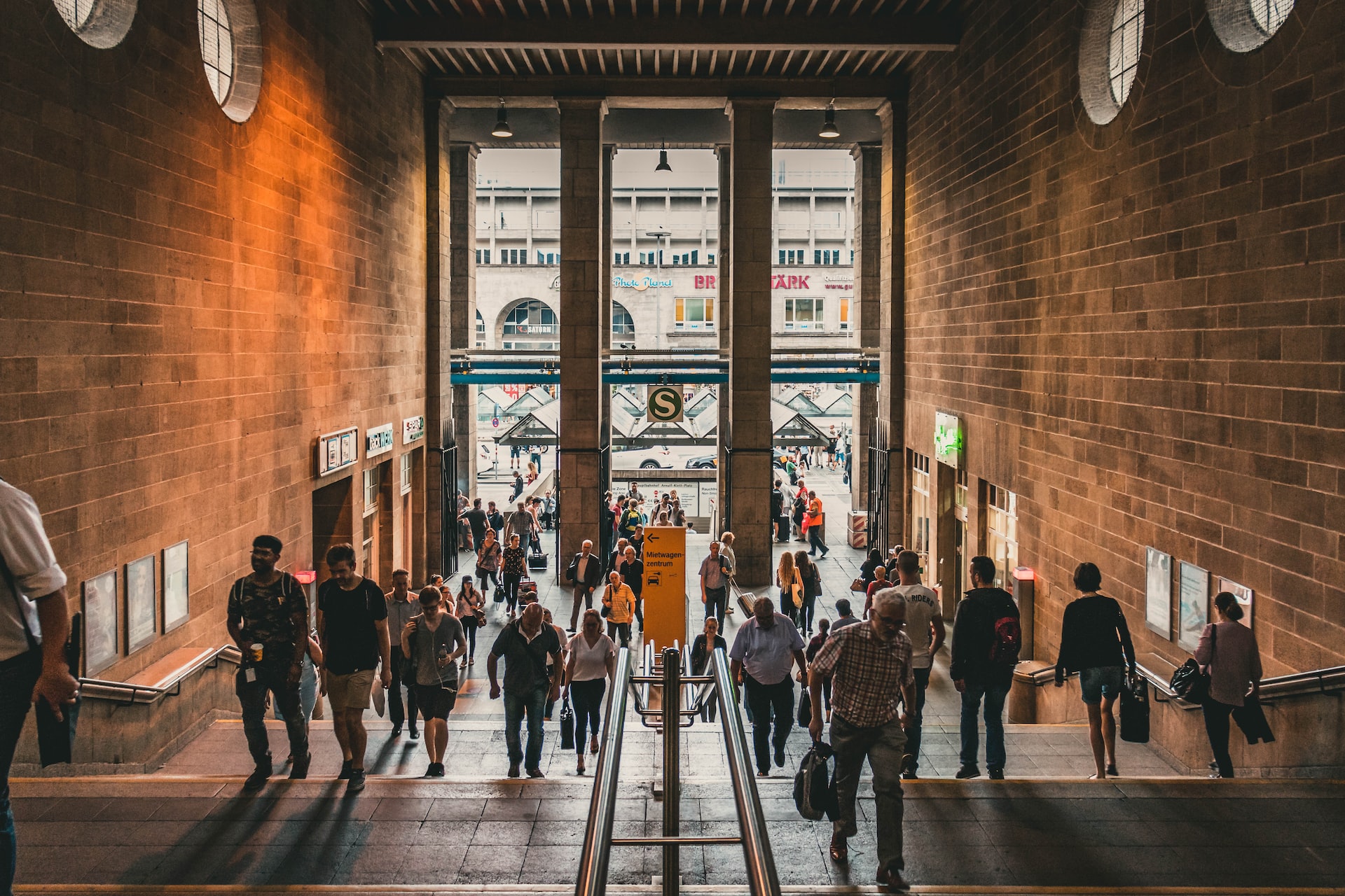 group of people entering a brown hallway